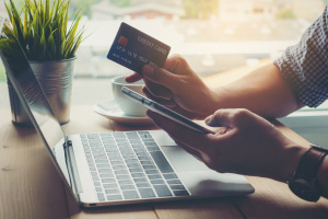 Woman using digital banking on laptop and phone